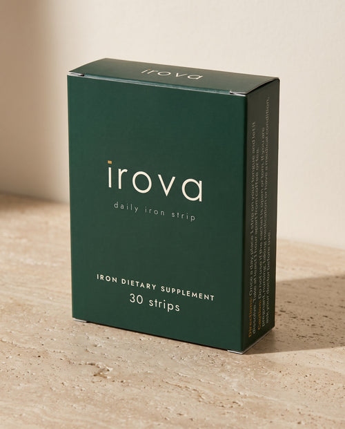 Irova Daily Iron Strips box, 30 strips, on a travertine shelf