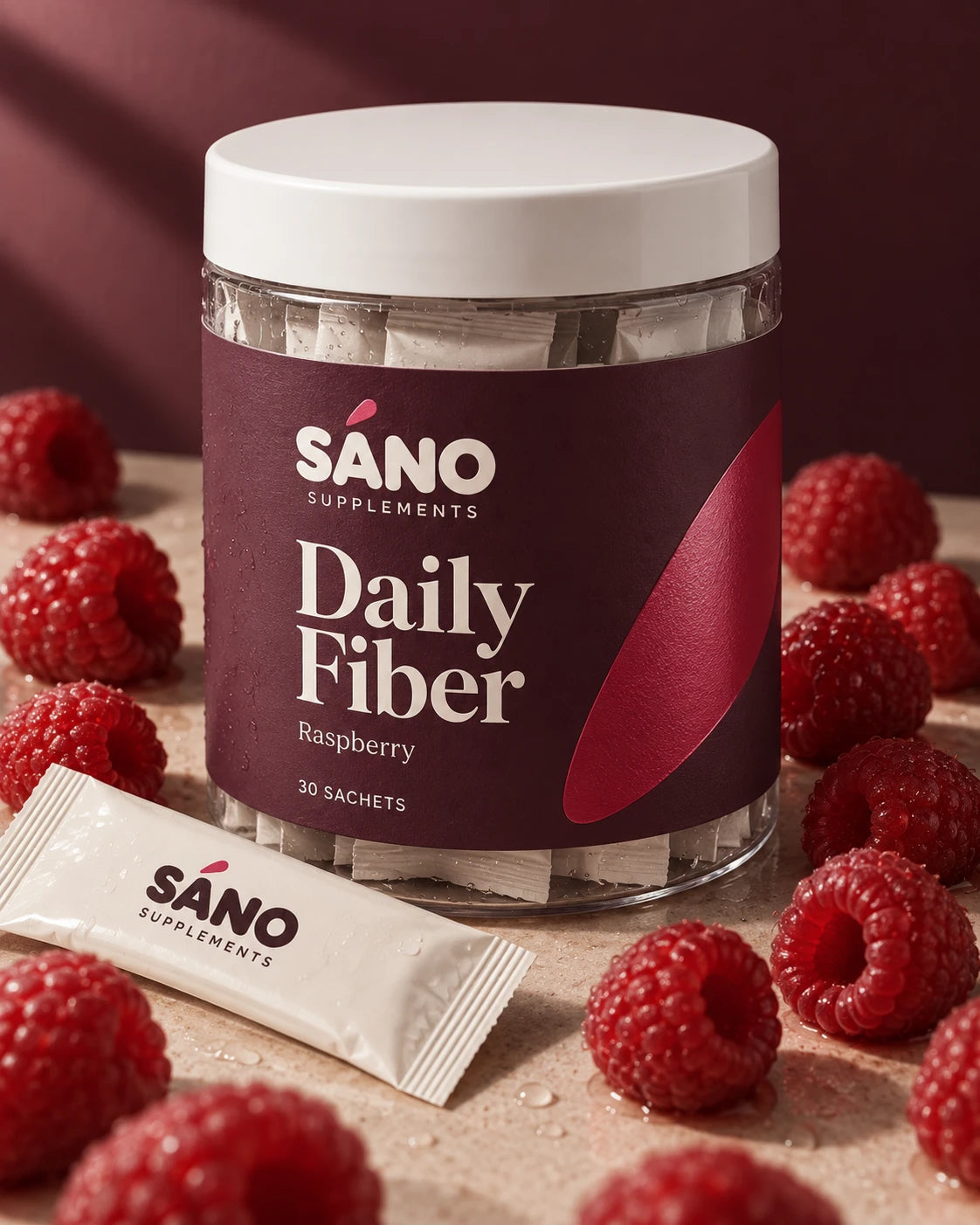Sáno Daily Fiber jar in raspberry, 30 sachets, surrounded by fresh raspberries