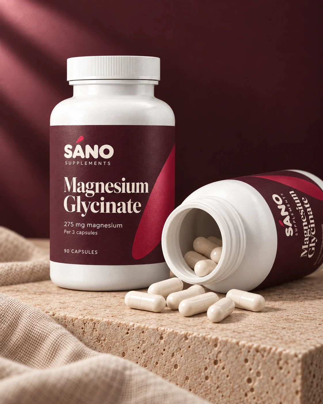 Two bottles of Sáno Magnesium Glycinate, one open with capsules spilling out