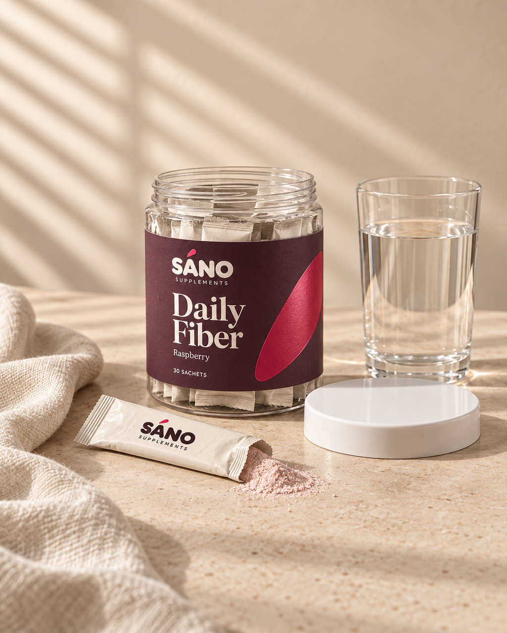 The jar beside a glass of water with a torn sachet and raspberry powder